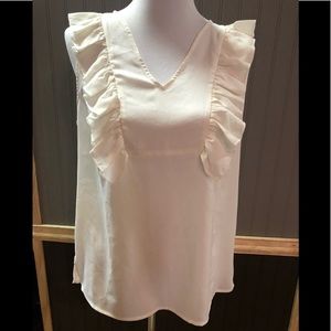 Ivory top, ruffled sleeves, the “Limited.”